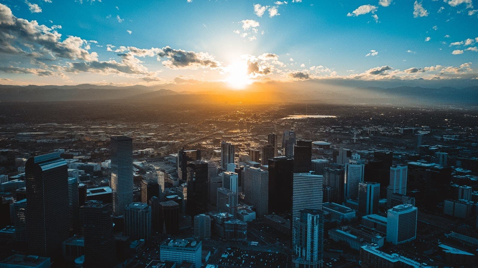 Denver skyline at the foot of the snow-capped Front Range with moving boxes in the foreground